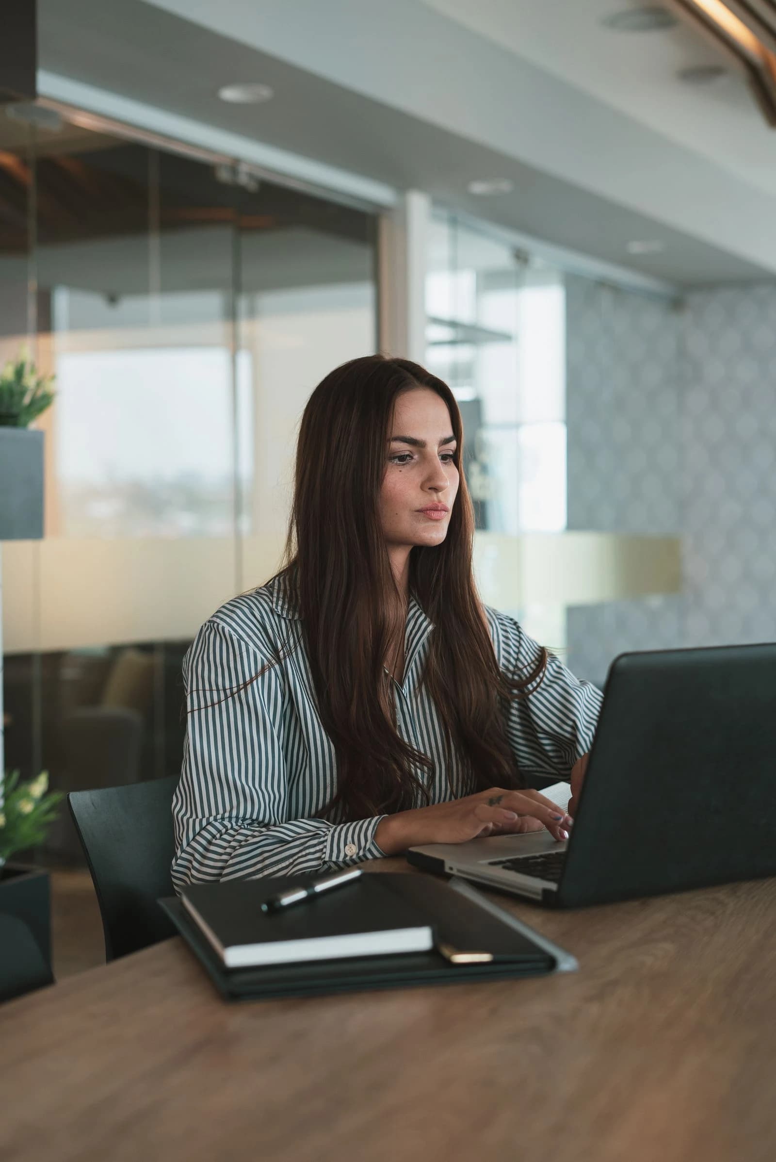 Professional working on a laptop in an office
